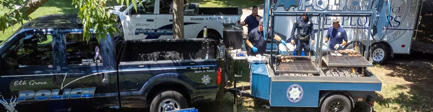 Officers skillfully manning the grill, offering a taste of camaraderie and delicious BBQ.